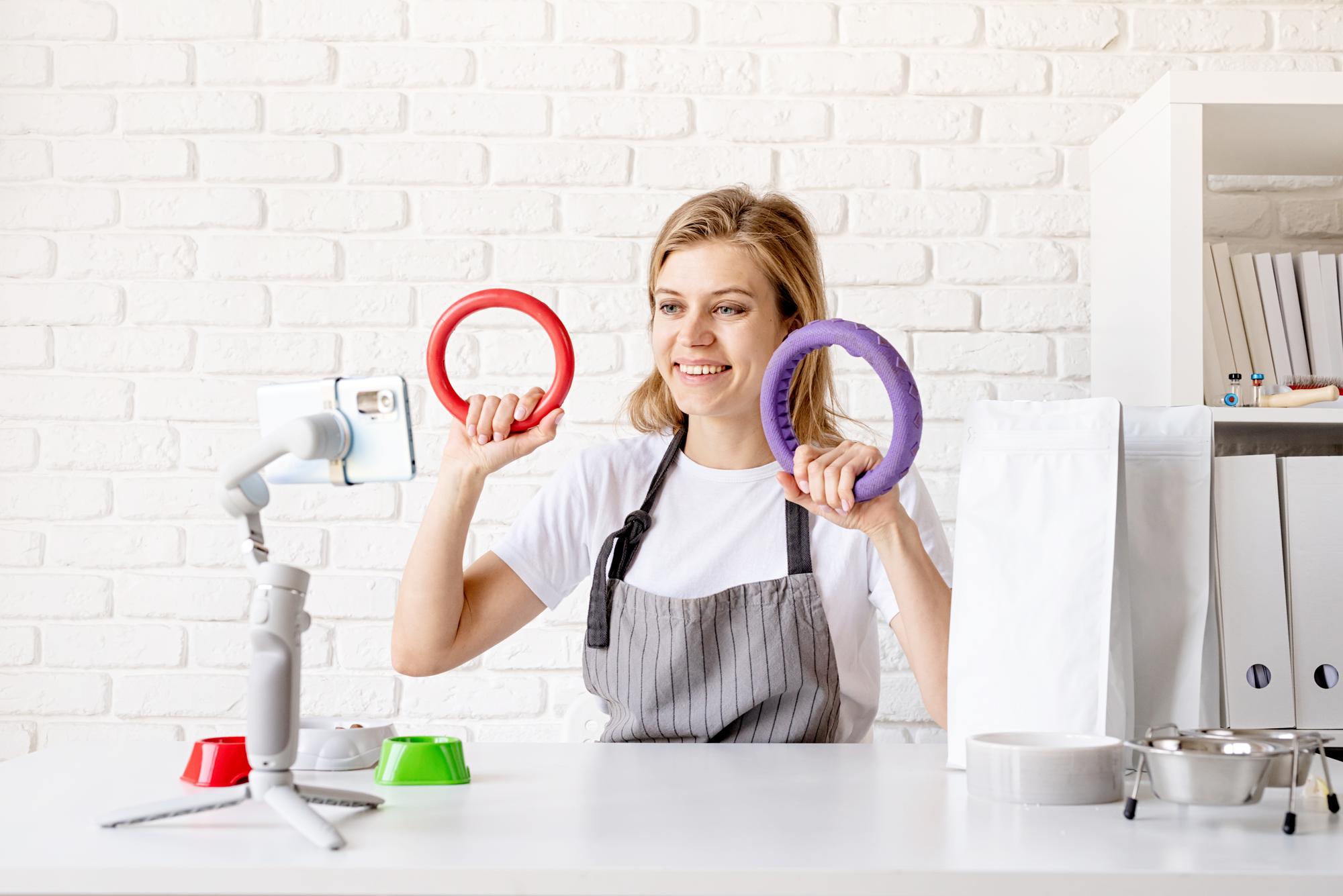 Lead instructor with embroidery hoop and tablet